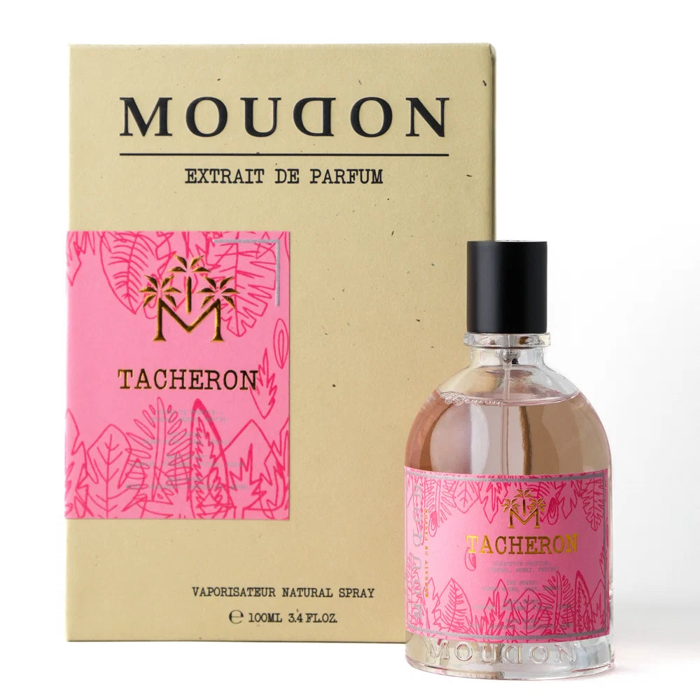 Moudon Tacheron extrait de parfum bottle with a pink tropical pattern label next to its beige cardboard packaging box.