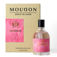 Moudon Tacheron extrait de parfum bottle with a pink tropical pattern label next to its beige cardboard packaging box.